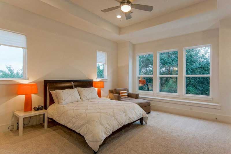 Modern Bedroom with Orange Bedside Lamps