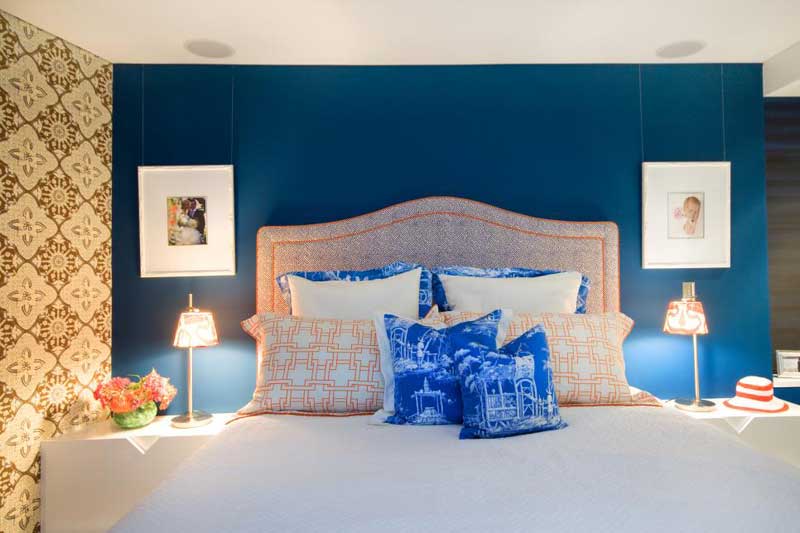 Blue and Orange Bedroom With Neutral Floral Wallpaper