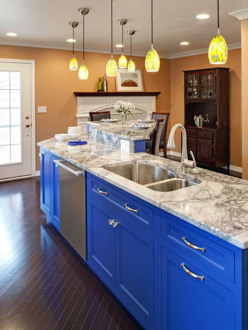 Bright Blue Kitchen Island With Marble Countertops