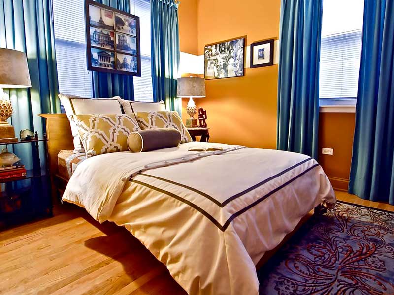 Orange Bedroom With Bold Blue Curtains
