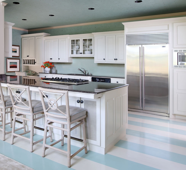White kitchen with blue striped floors and bar stools