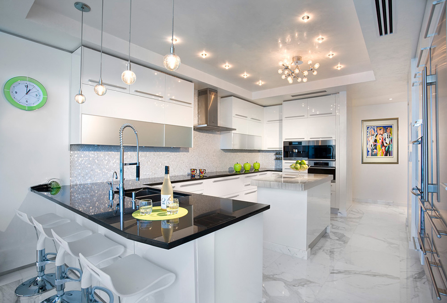 Contemporary white kitchen with marble flooring and white bar stools. Kitchen with sputnik chandelier over kitchen island with marble countertop