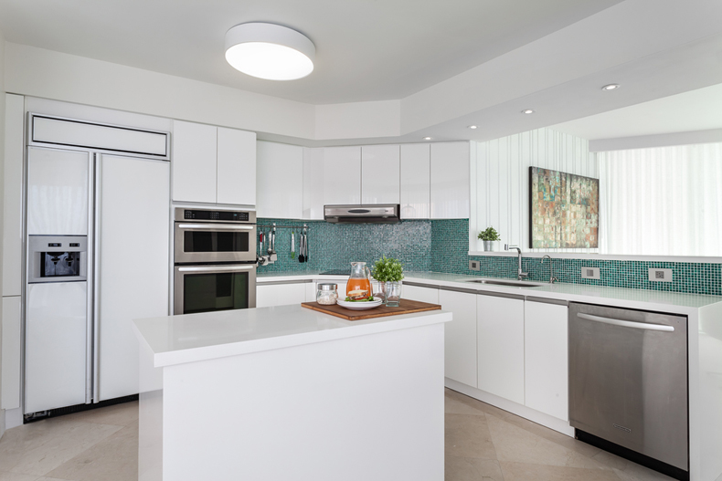 White kitchen with green mosaic tile backsplash