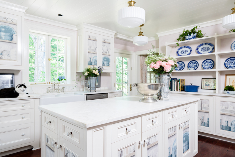 White kitchen with drum shade ceiling light over white wooden kitchen island with laminate countertop 