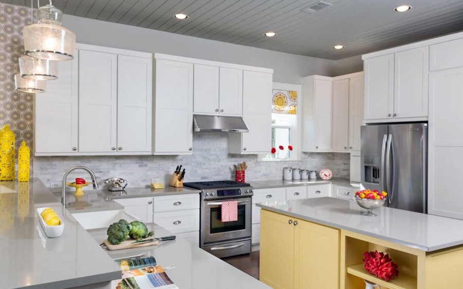 Small white kitchen with wooden kitchen island with gray quartz countertop
