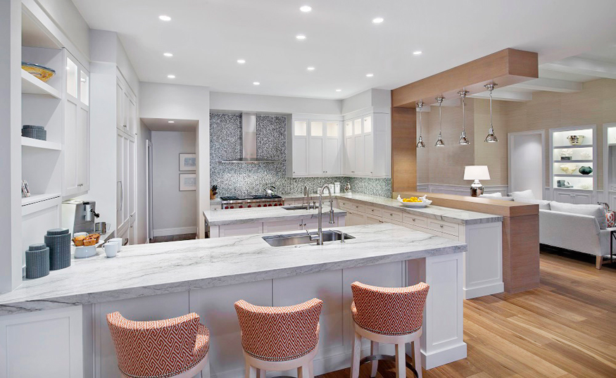 Modern white kitchen with gray mosaic backsplash. Kitchen with upholstered barstools and white kitchen island with marble countertops