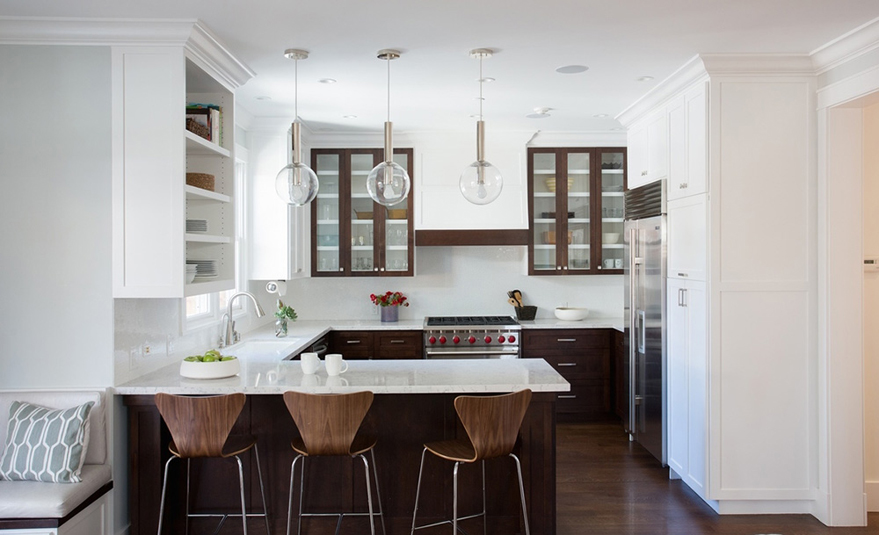 Small white kitchen with modern wood bar stools and glass pendant lights
