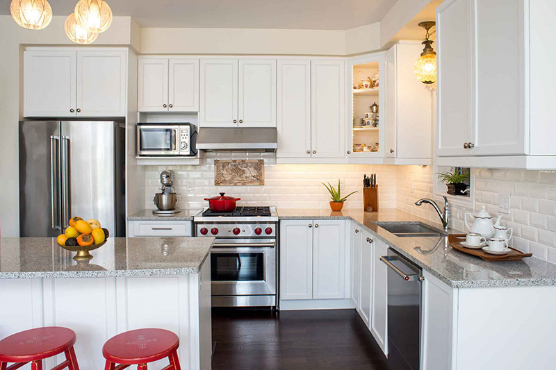 White kitchen design with granite countertops