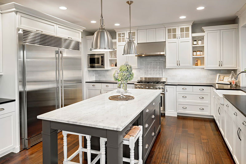 White kitchen with hardwood flooring