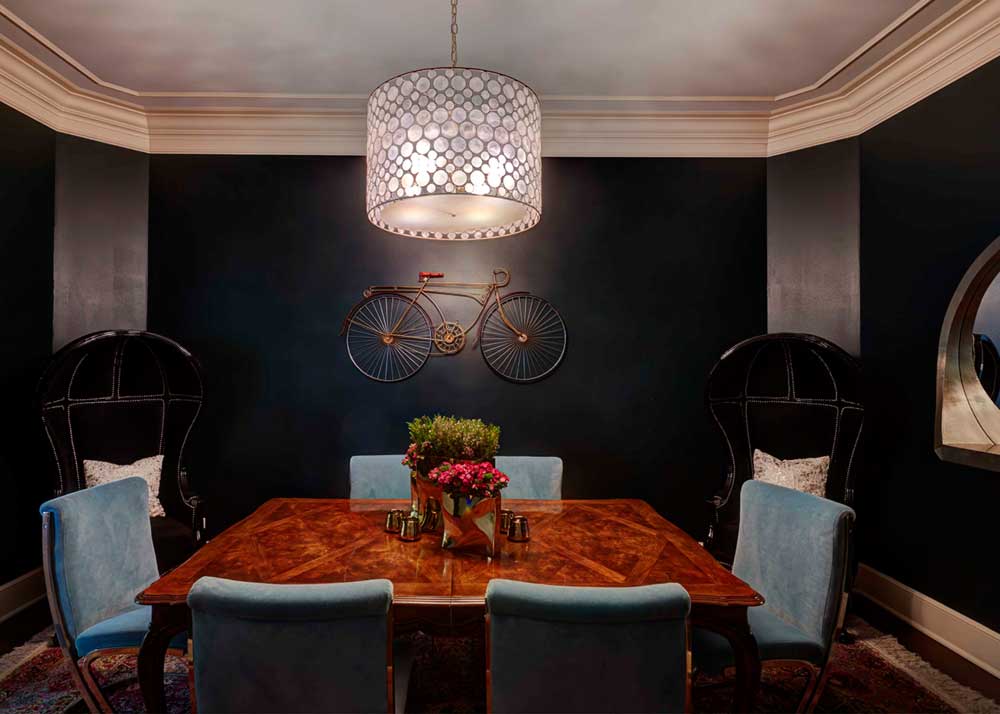 black dining room with drum shade ceiling light