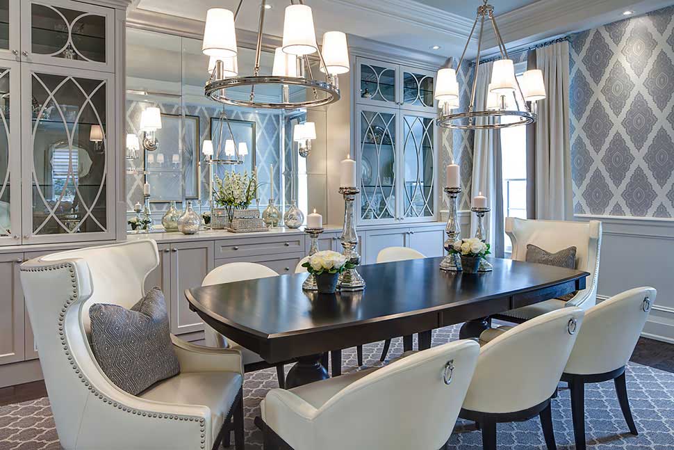 white dining room with pendant light and candle table lamps