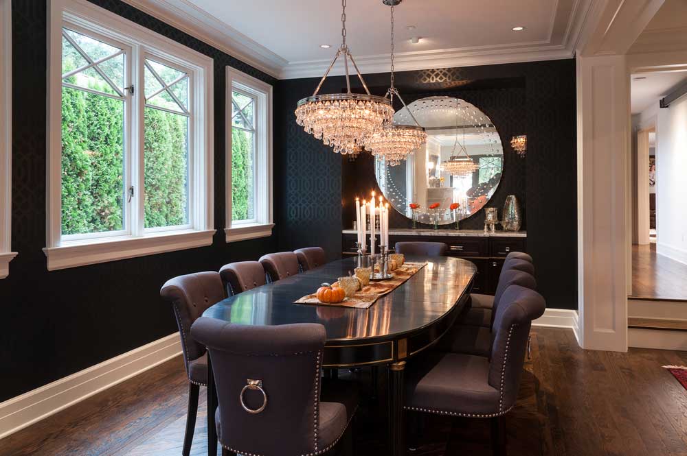black dining room with crystal chandeliers and candle table lamps