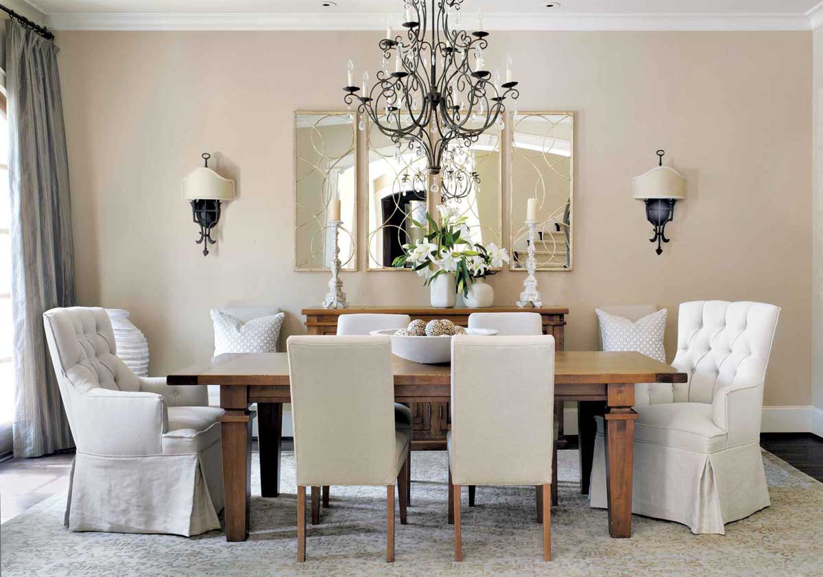 dining room with chandeliers and wall sconces