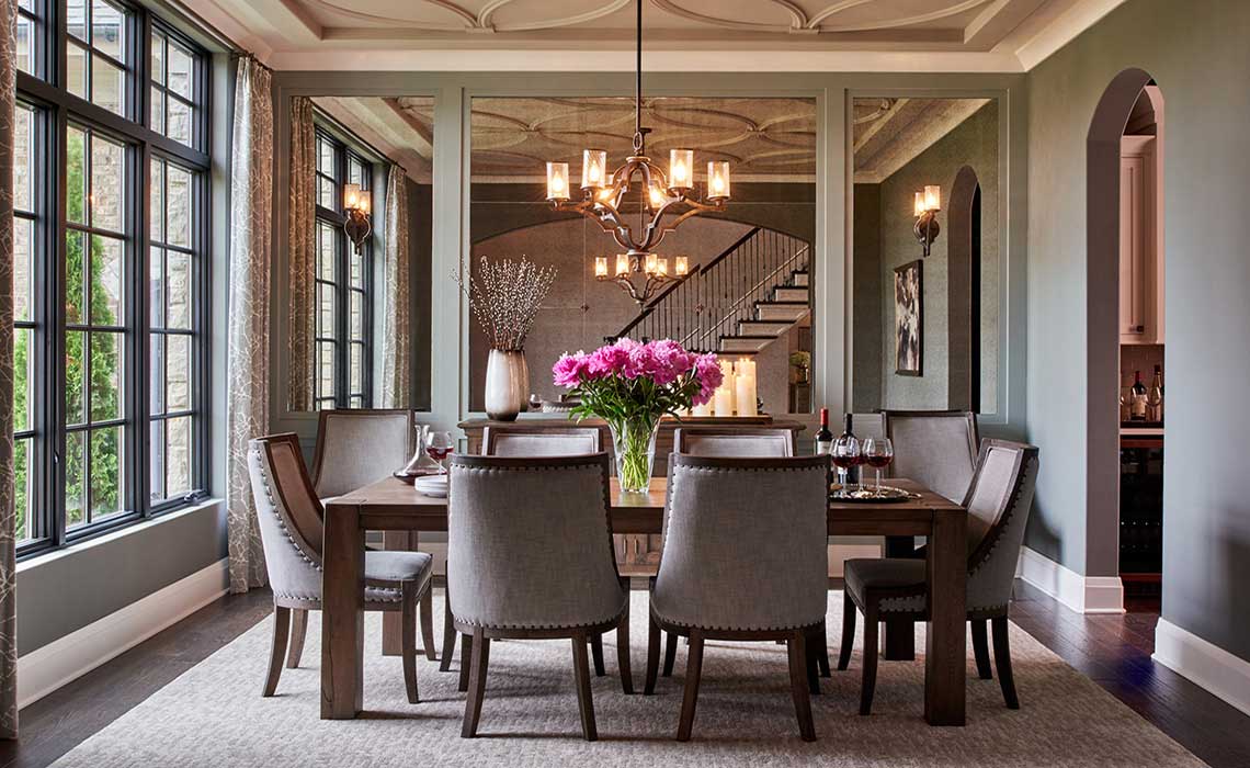 gray formal dining room with chandeliers