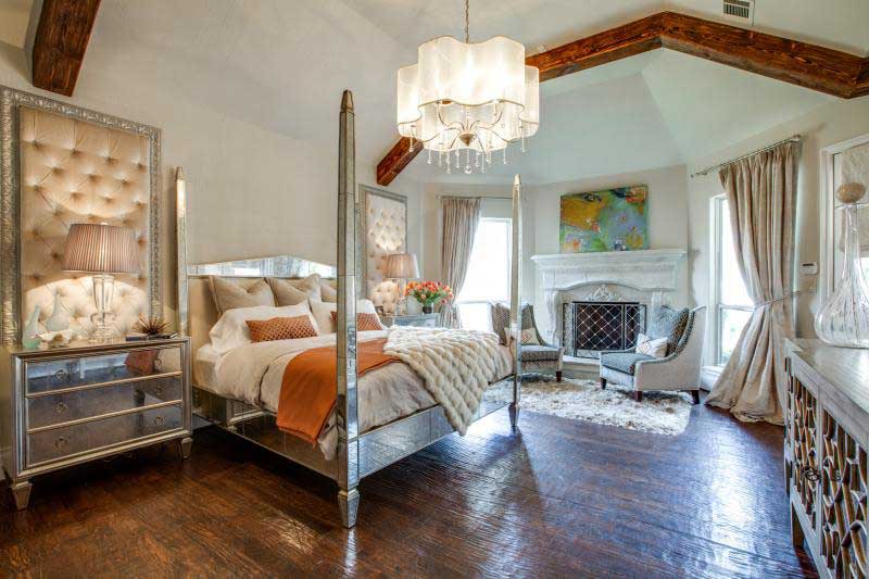 traditional master bedroom with chandelier and table lamps 