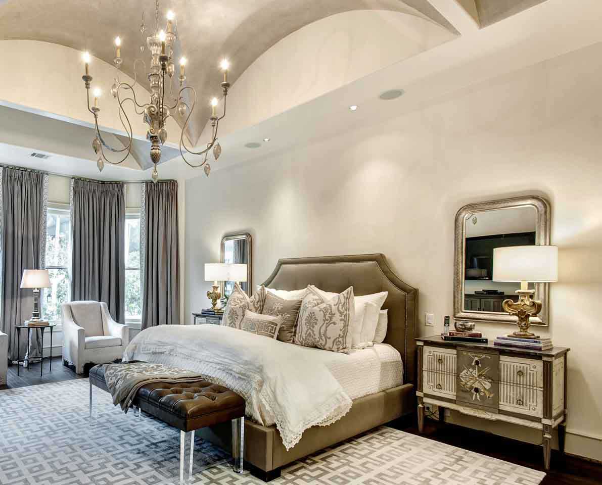 white master bedroom with chandle chandelier and table lamps