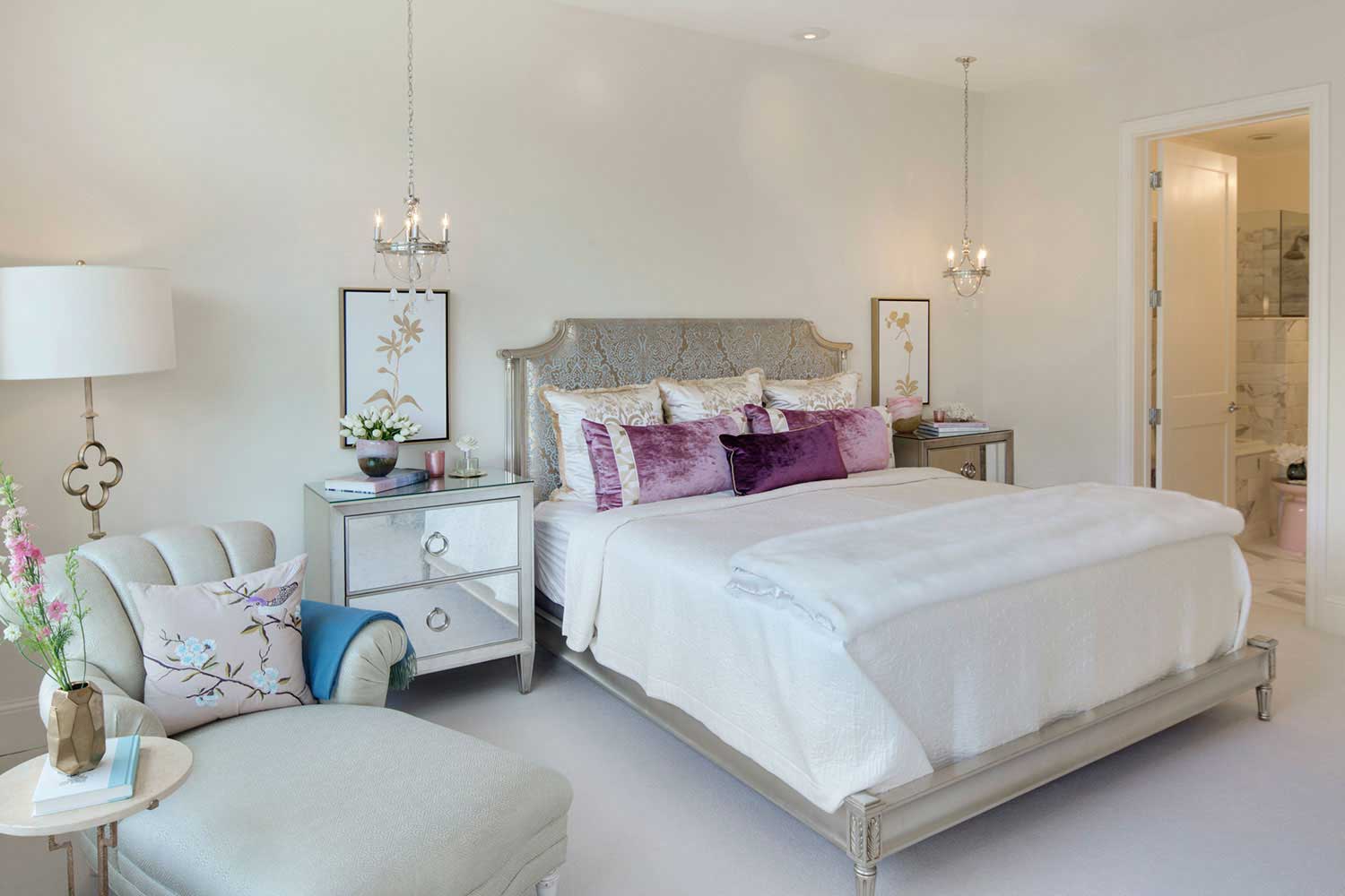 white bedroom with pendant chandeliers