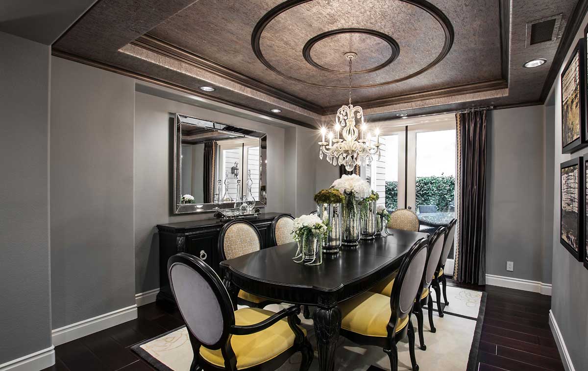 gray and black dining room with candle chandelier