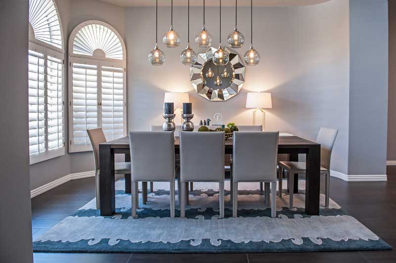 contemporary dining room with table lamps and glass pendant lights