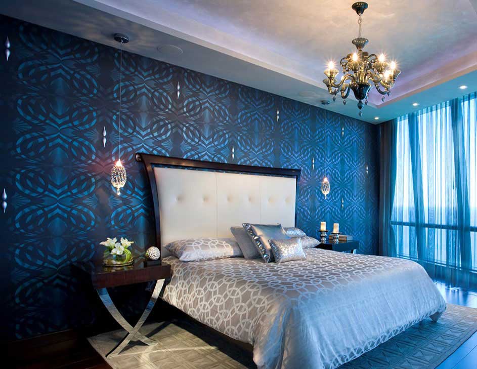 blue bedroom with gold chandelier and pendant lighting