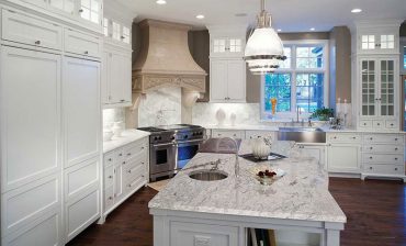 White kitchen with river white granite countertops