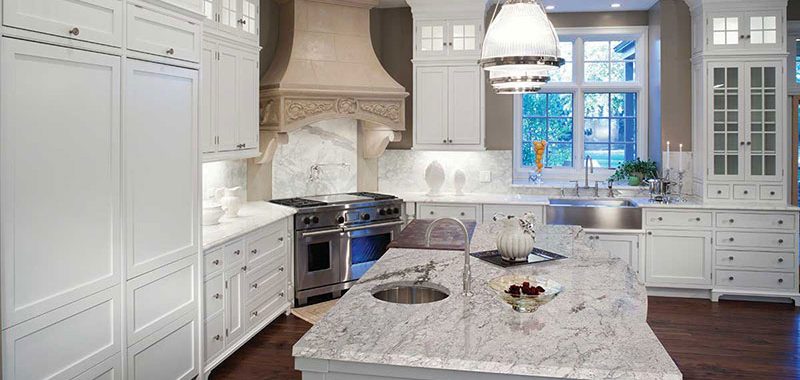 White kitchen with river white granite countertops
