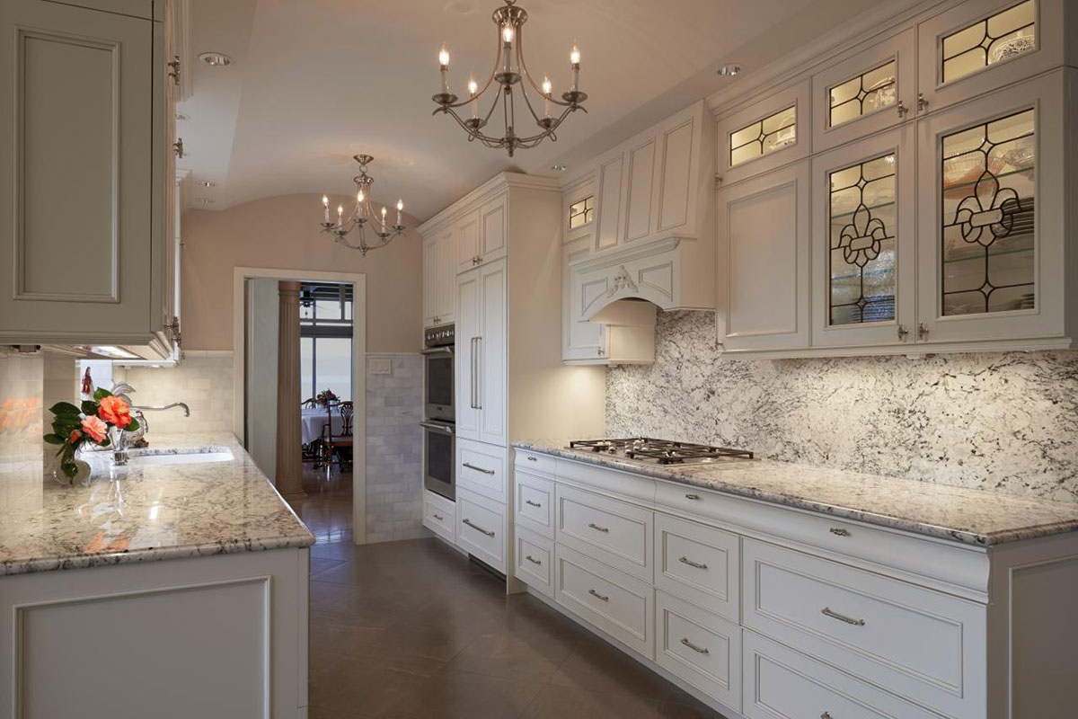 Kitchen with white cabinets and white ice granite countertops