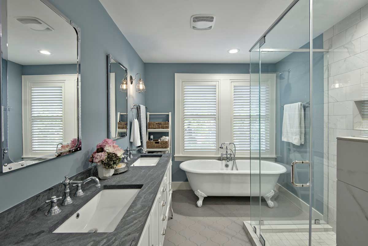 gray bathroom with clear glass wall sconces