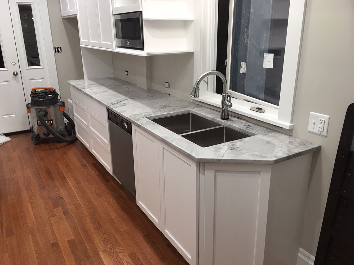 White kitchen with super white granite countertops