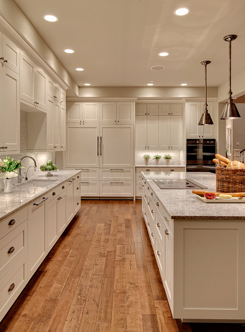 Traditional white kitchen with kashmir white granite countertops