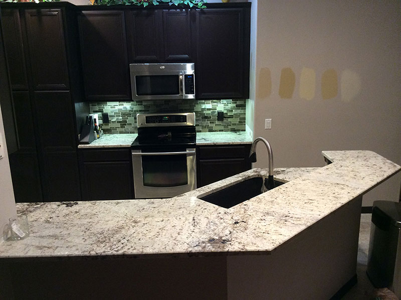 Black cabinets with white galaxy granite countertops