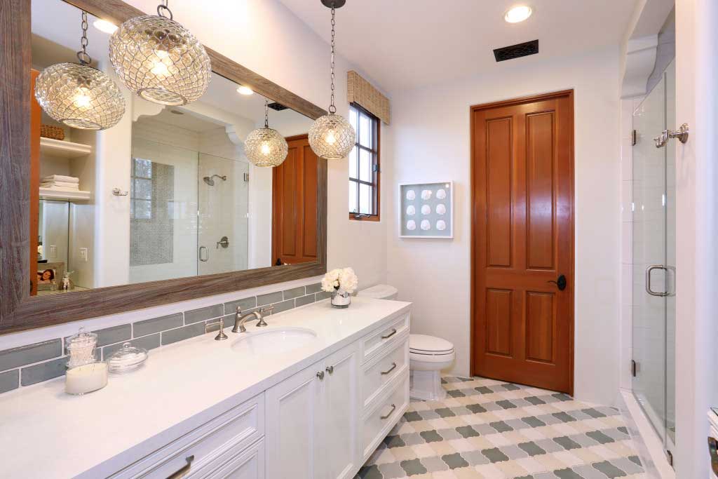 bathroom with metal globe pendant lights