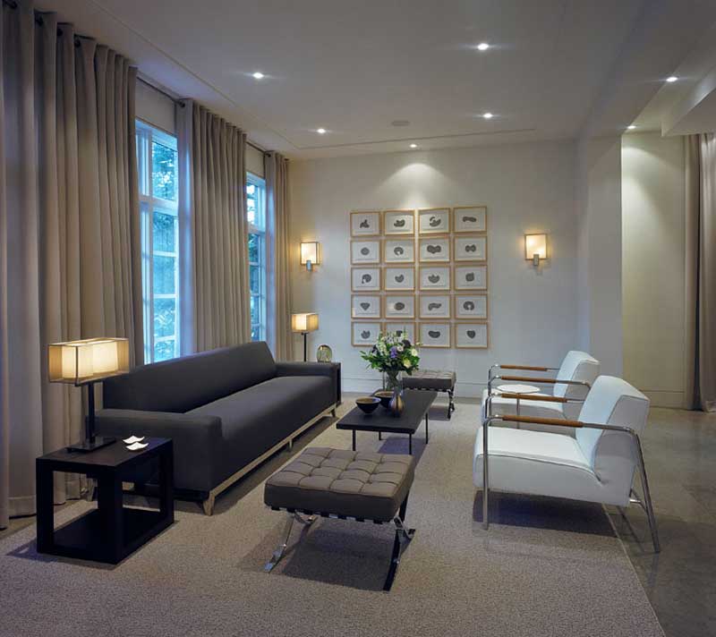 living room with wall sconces and table lamps