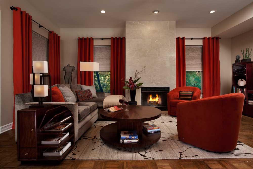 red living room with fireplace, table lamps and recessed lighting