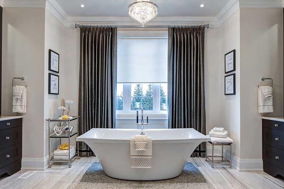 bathroom with chandelier and natural light