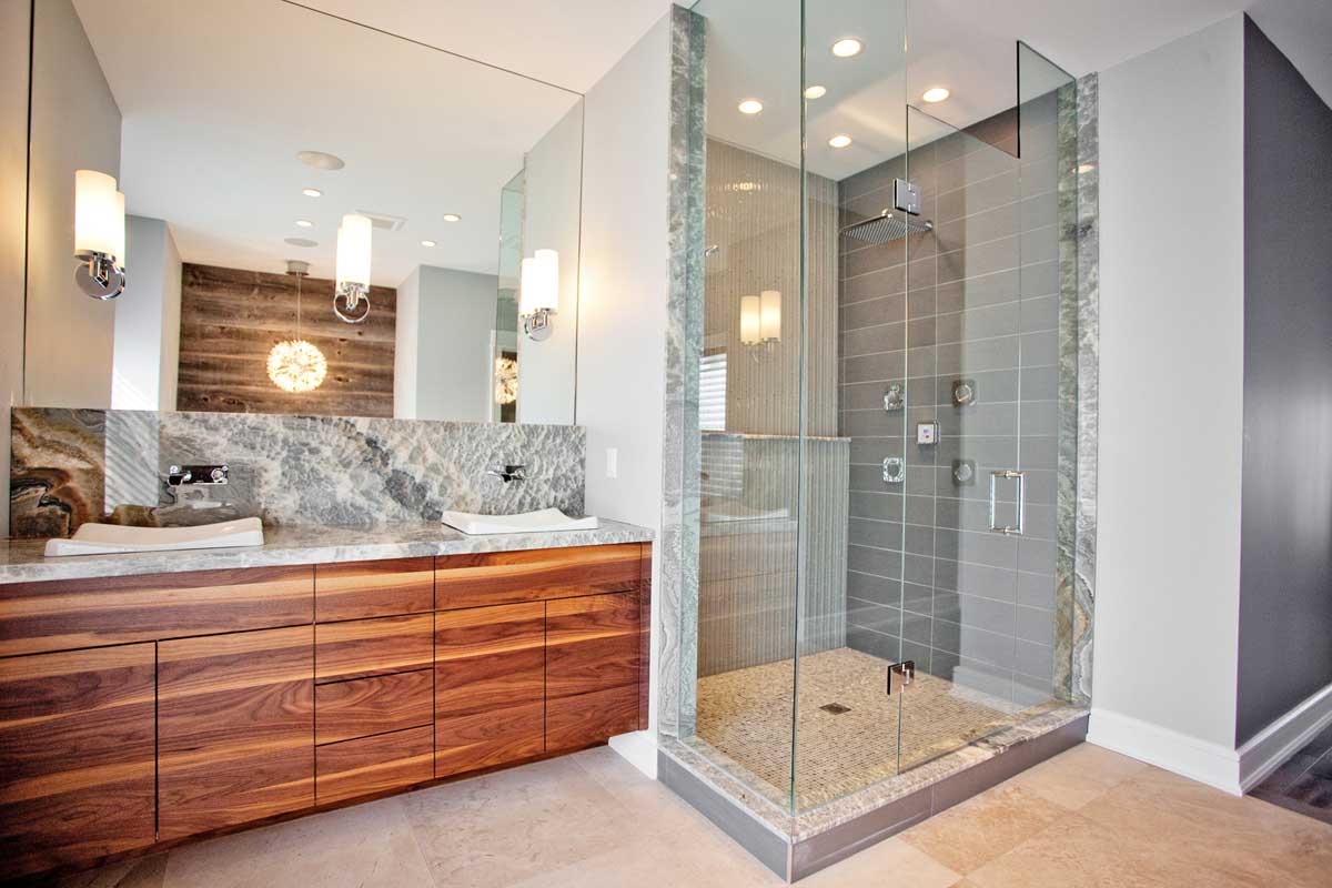 bathroom with wall sconces and burst pendant light