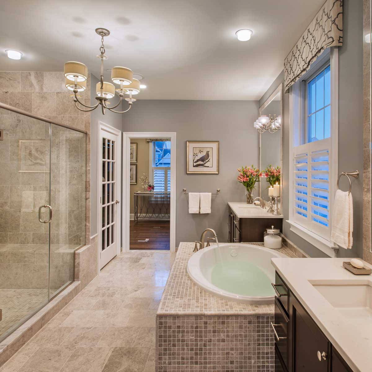 gray master bathroom with flush mount ceiling light and chandelier 