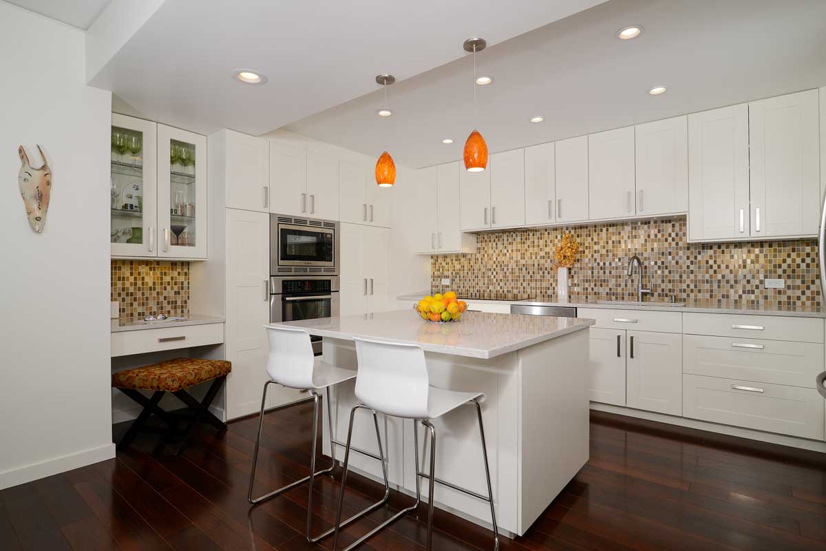 white kitchen with orange glass pendant light