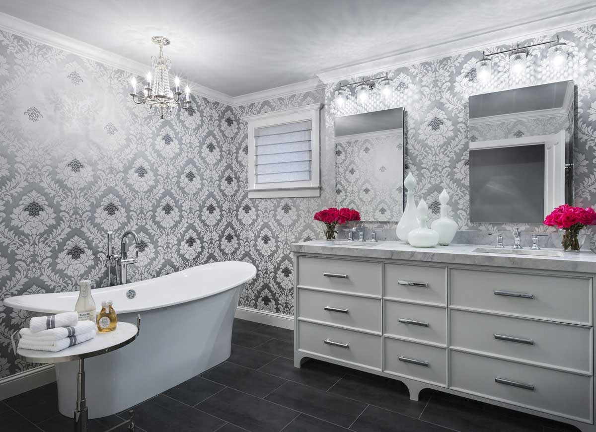 white and gray bathroom with crystal chandelier and wall sconces