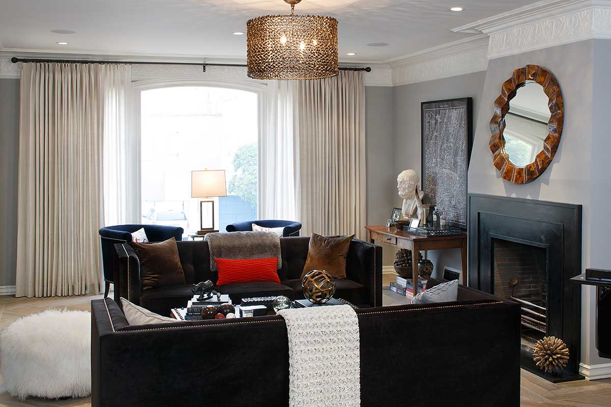 black living room with gold drum pendant light 