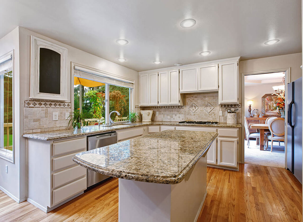 White cabinets with santa cecilia granite