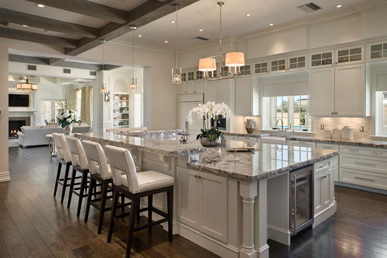 Bianco antico granite countertops with white cabinets and dark wood floring