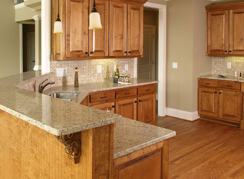 Giallo ornamental granite with light wood cabinets