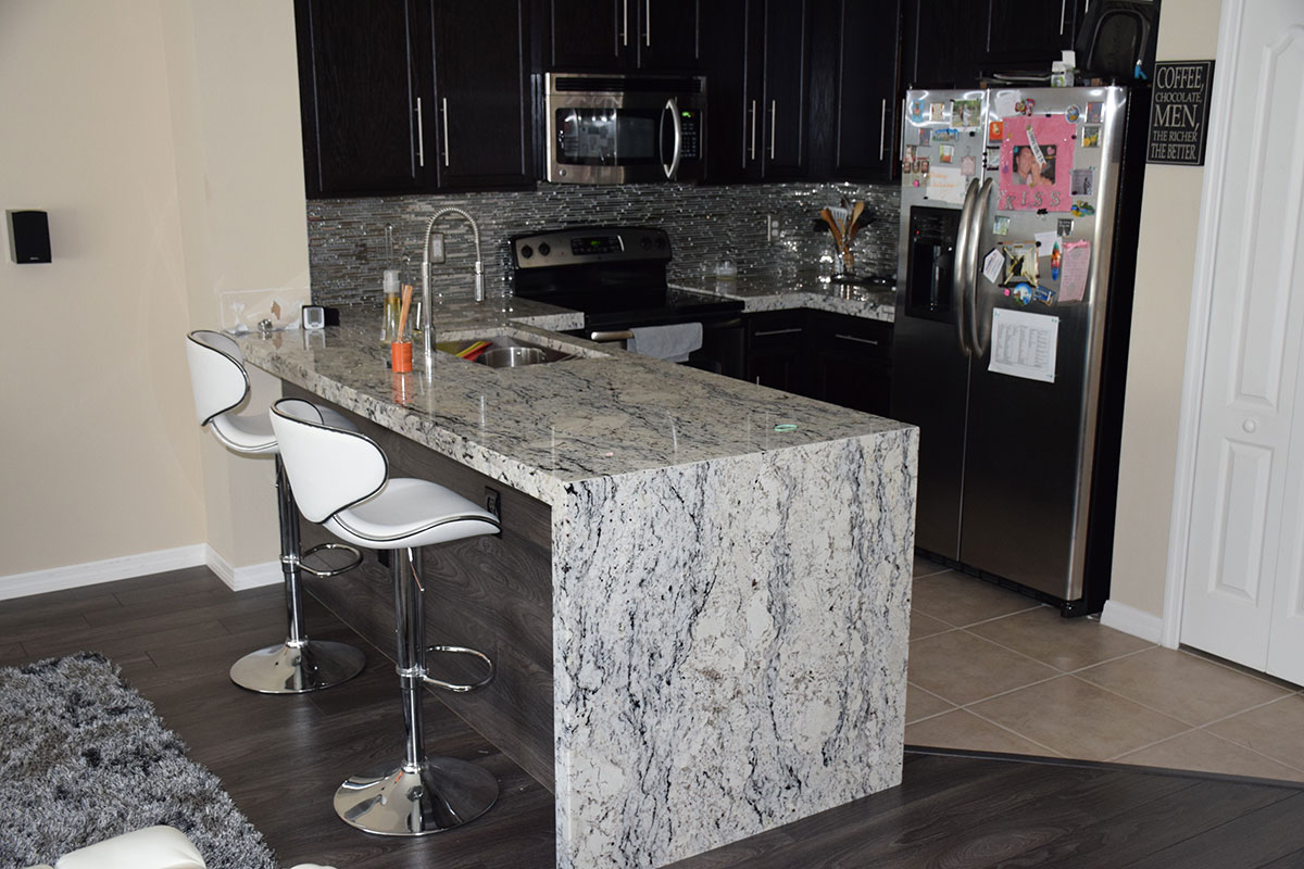 Black cabinets with white ice granite