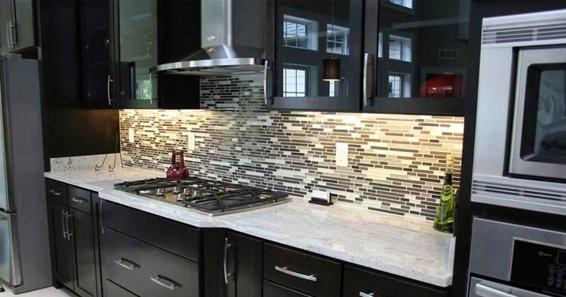 Dark kitchen cabinets with river white granite