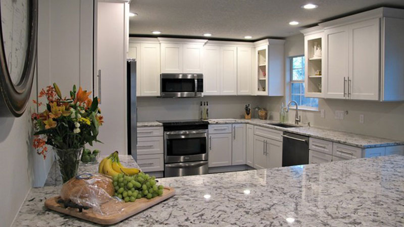 White kitchen cabinets with white ice granite