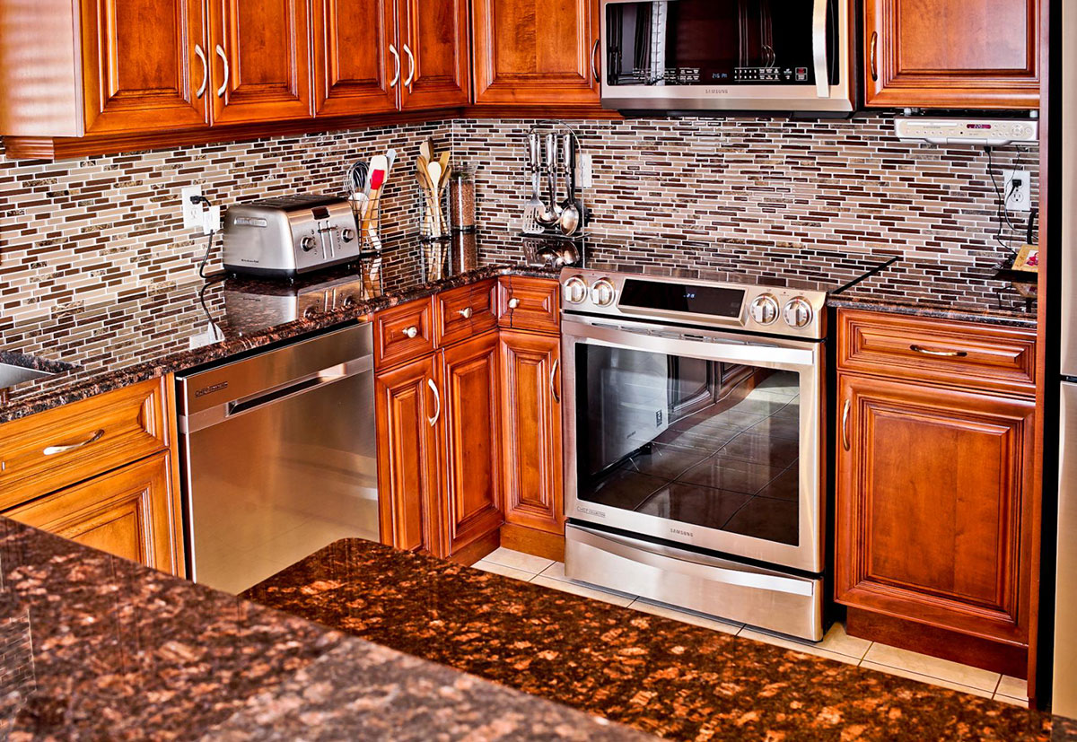 dark-brown-cabinets-white-kitchen-cabinets-stone-backsplash-kitchen