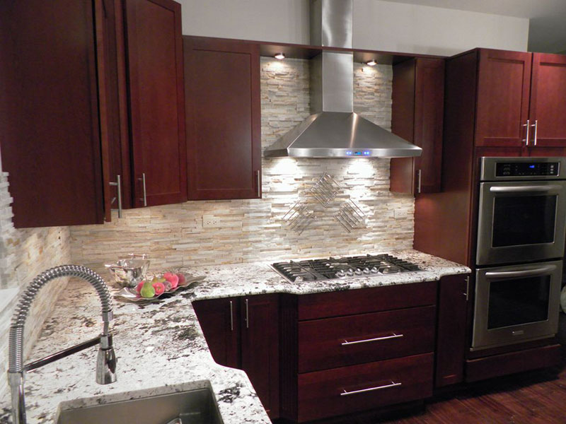 Small kitchen with bianco antico granite countertops and cherry cabinets