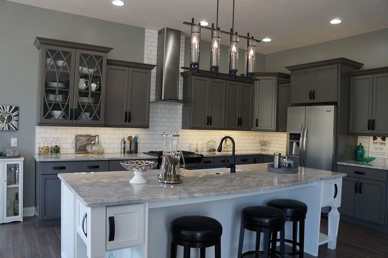 Gray cabinets with river white granite