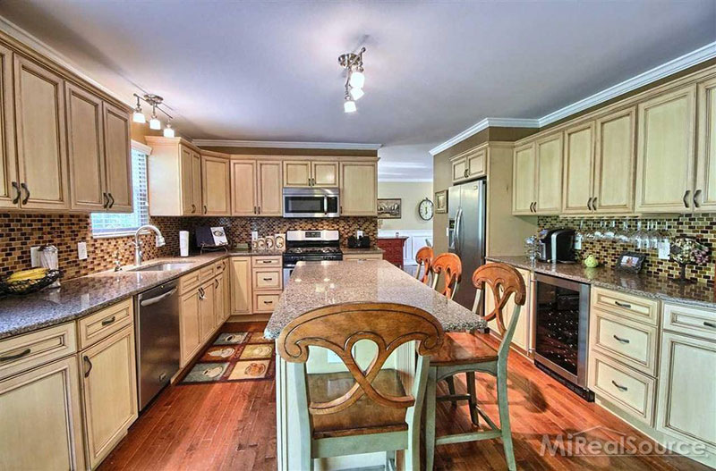 Gray cabinets with new caledonia granite